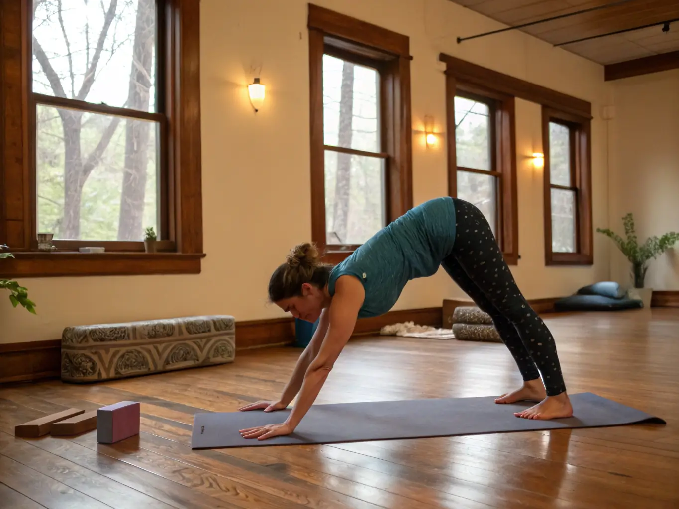 A person doing a yoga pose in a serene studio at Reflections Spa, focusing on balance and flexibility.